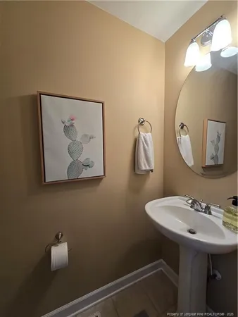 a bathroom with a sink mirror and vanity