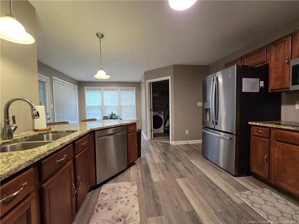 a kitchen with a sink appliances and cabinets