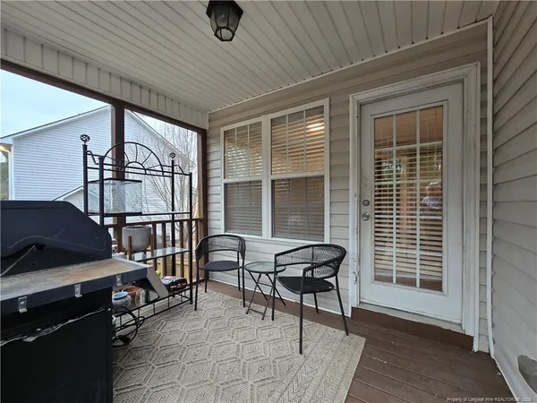 a balcony with furniture and a window