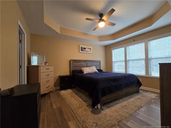 a bedroom with a large bed and a large window