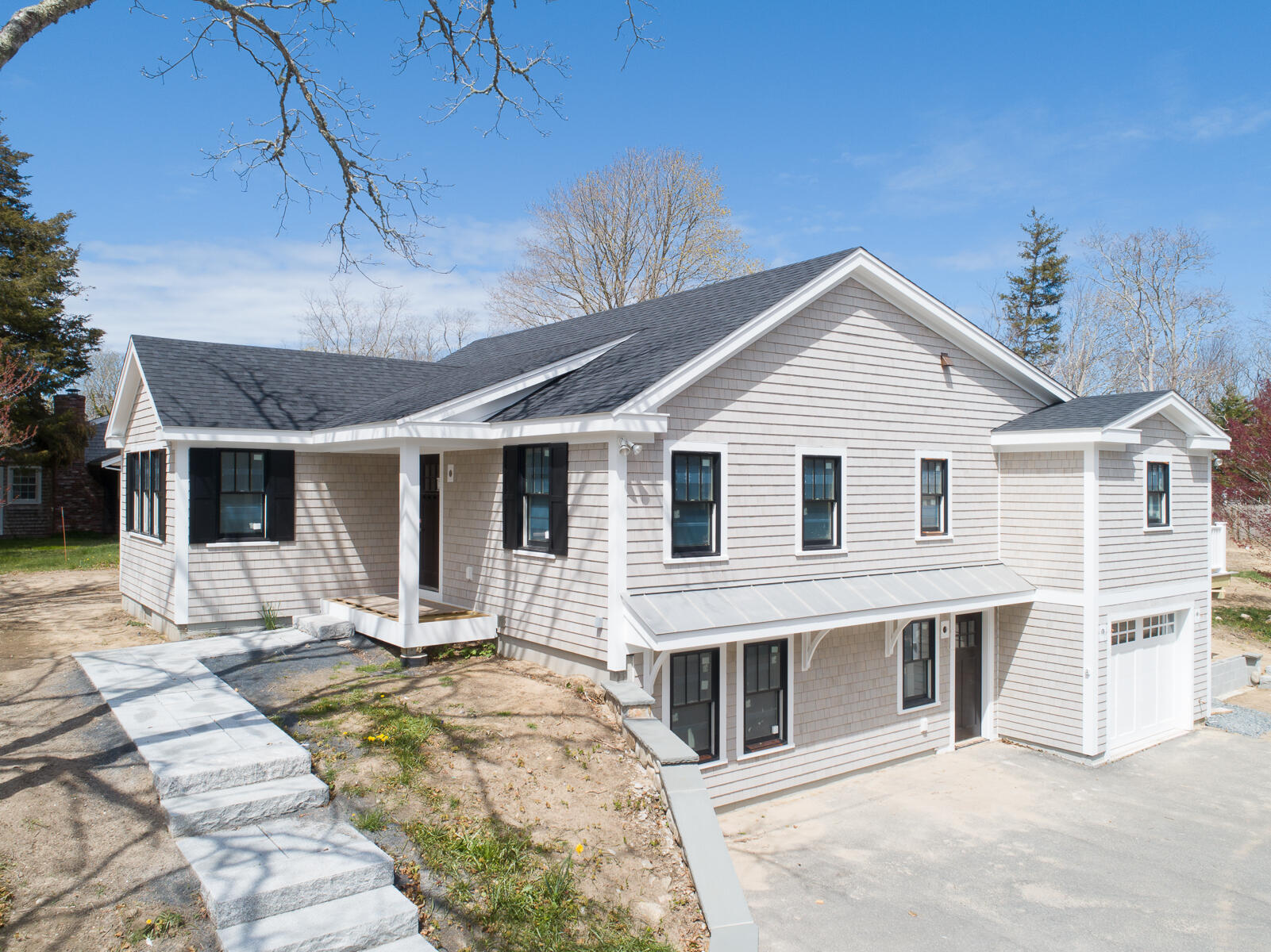 86 West Road Orleans, MA 02653 - Photo 2 of 15 a view of a white house with wooden walls and floor to ceiling window