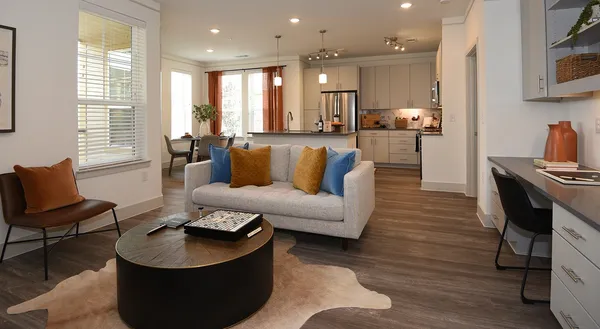a living room with furniture and wooden floor