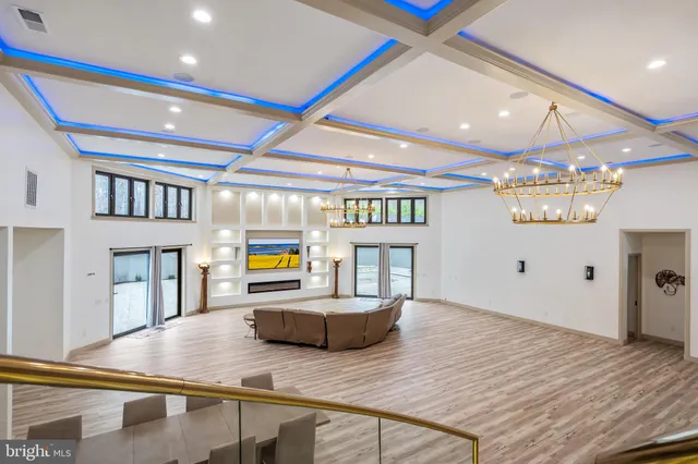 a view of empty room with wooden floor and windows