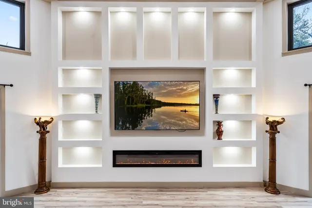 a bathroom with double vanity sinks a vanity a lamp and a mirror