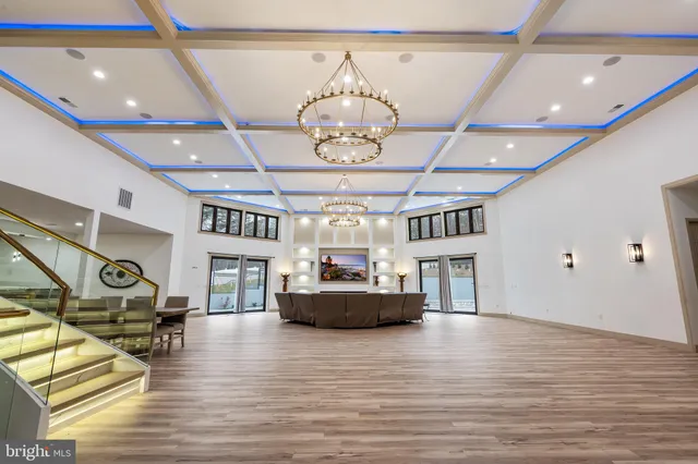 a view of a dining room with furniture wooden floor and chandelier