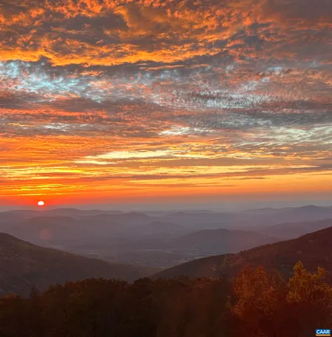 a view of a dining room with furniture and a chandelier