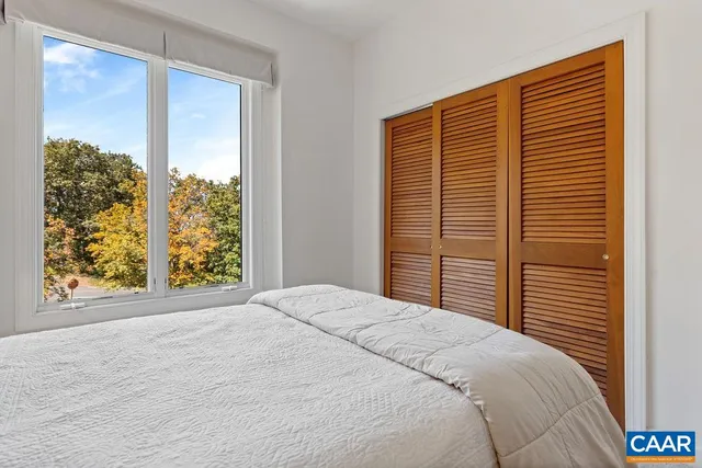 a bedroom with a bed and cabinet