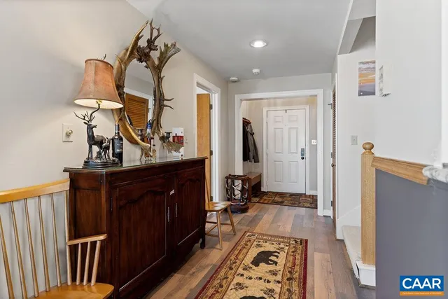 a view of a hallway with wooden floor