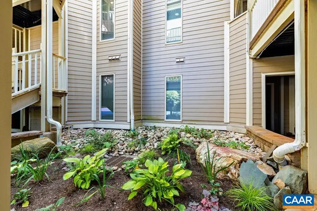 a view of residential houses with yard and wooden fence