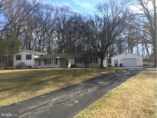 5095 Grave Run Road Manchester, MD 21102 - Photo 1 of 17 a front view of a house with a large trees and a big yard