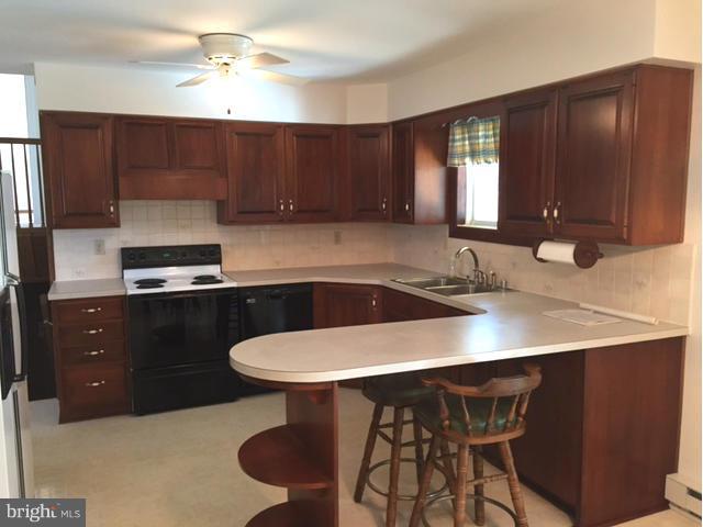 5095 Grave Run Road Manchester, MD 21102 - Photo 3 of 17 a kitchen with a sink cabinets and wooden floor
