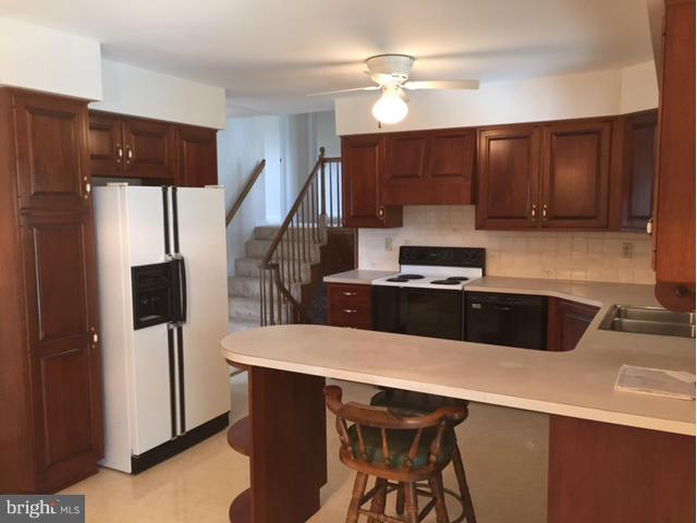 5095 Grave Run Road Manchester, MD 21102 - Photo 4 of 17 a kitchen with a sink a refrigerator and cabinets