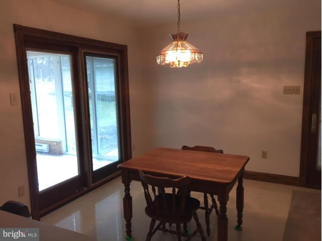 5095 Grave Run Road Manchester, MD 21102 - Photo 5 of 17 a view of a dining room with furniture and chandelier