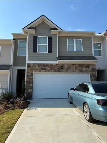 a front view of a house with parking space
