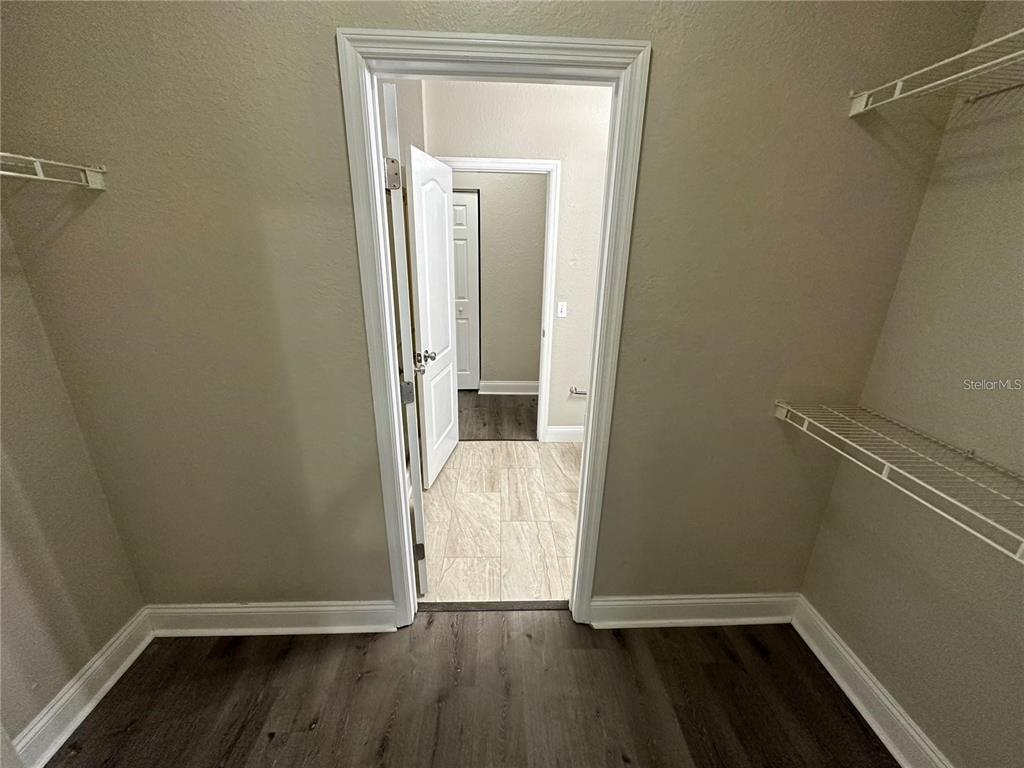 3307 South Kirkman Road, Unit 129 Orlando, FL 32811 - Photo 14 of 24 a view of a room with wooden floor and a small window
