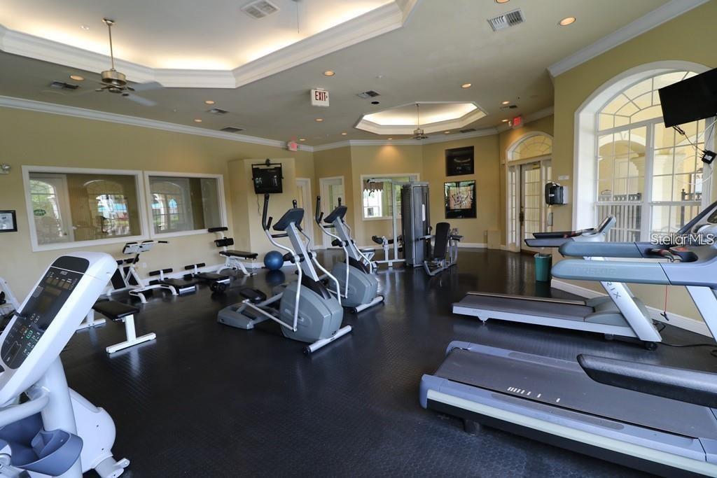 3307 South Kirkman Road, Unit 129 Orlando, FL 32811 - Photo 23 of 24 a living room with furniture gym equipment and a large window
