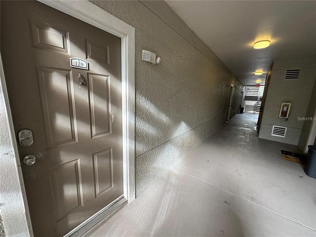 3307 South Kirkman Road, Unit 129 Orlando, FL 32811 - Photo 3 of 24 a view of a refrigerator in kitchen and an empty room