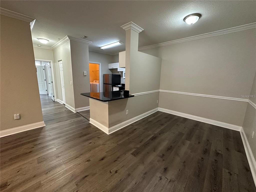 3307 South Kirkman Road, Unit 129 Orlando, FL 32811 - Photo 5 of 24 a view of a kitchen with wooden floor and electronic appliances