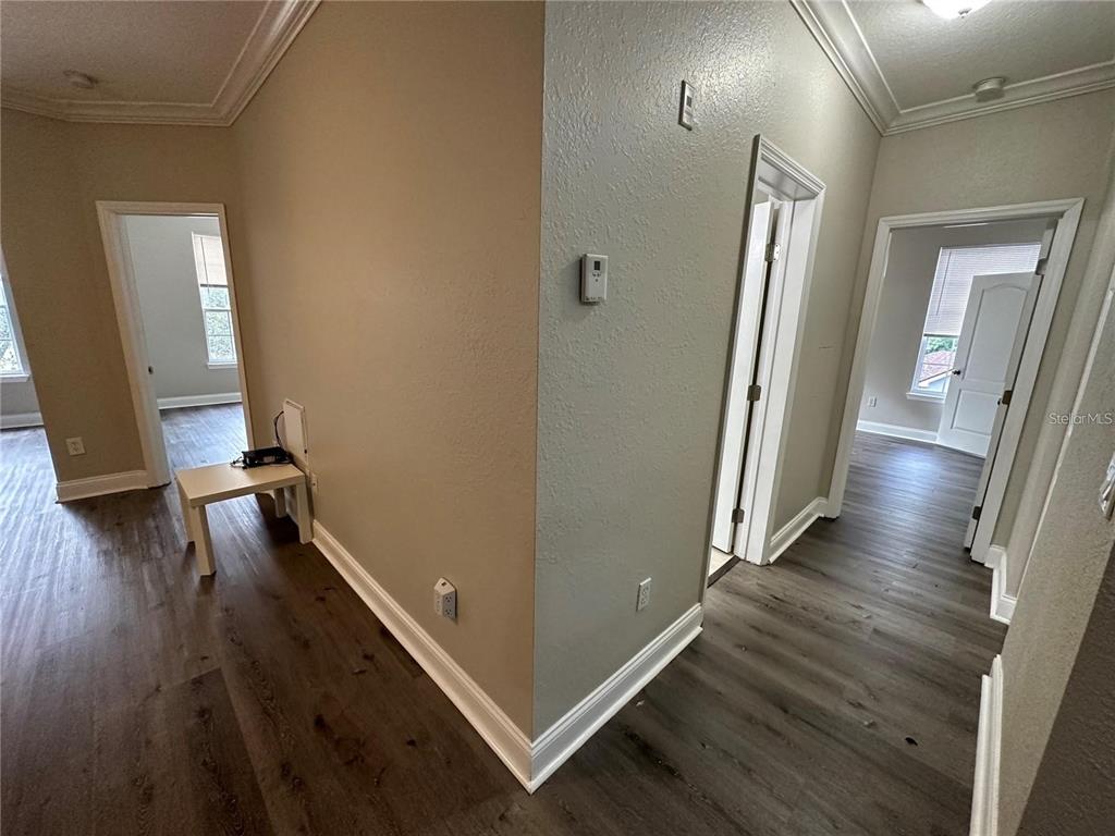3307 South Kirkman Road, Unit 129 Orlando, FL 32811 - Photo 8 of 24 a view of a hallway with wooden floor
