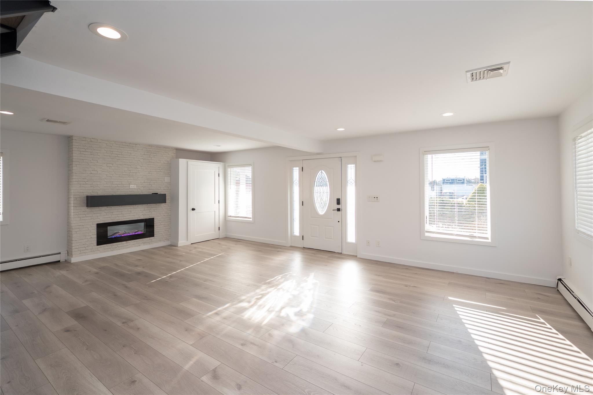 15 Roneck Court Shirley, NY 11967 - Photo 12 of 44 a view of an empty room with a window and fireplace