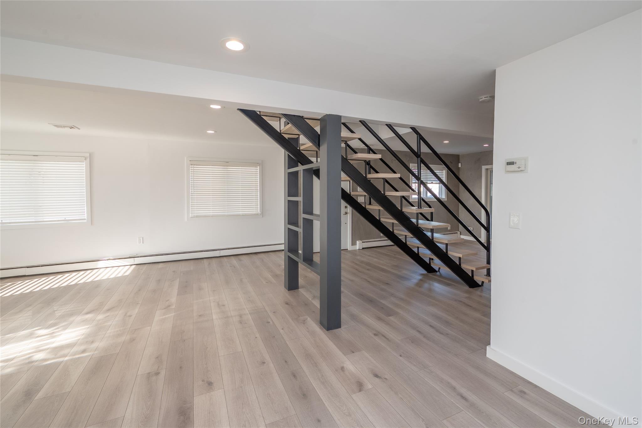 15 Roneck Court Shirley, NY 11967 - Photo 14 of 44 wooden floor in an empty room with wooden floor