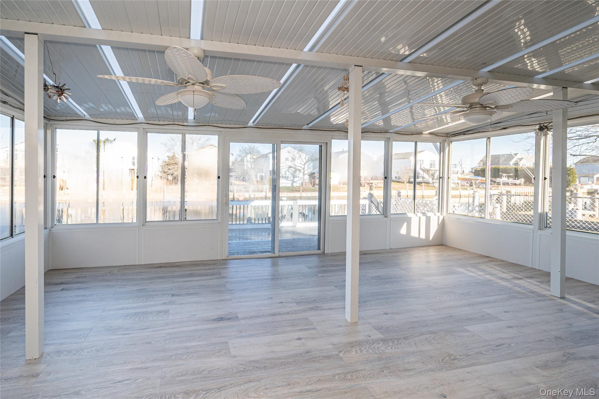 15 Roneck Court Shirley, NY 11967 - Photo 15 of 44 a view of an empty room with wooden floor and a window