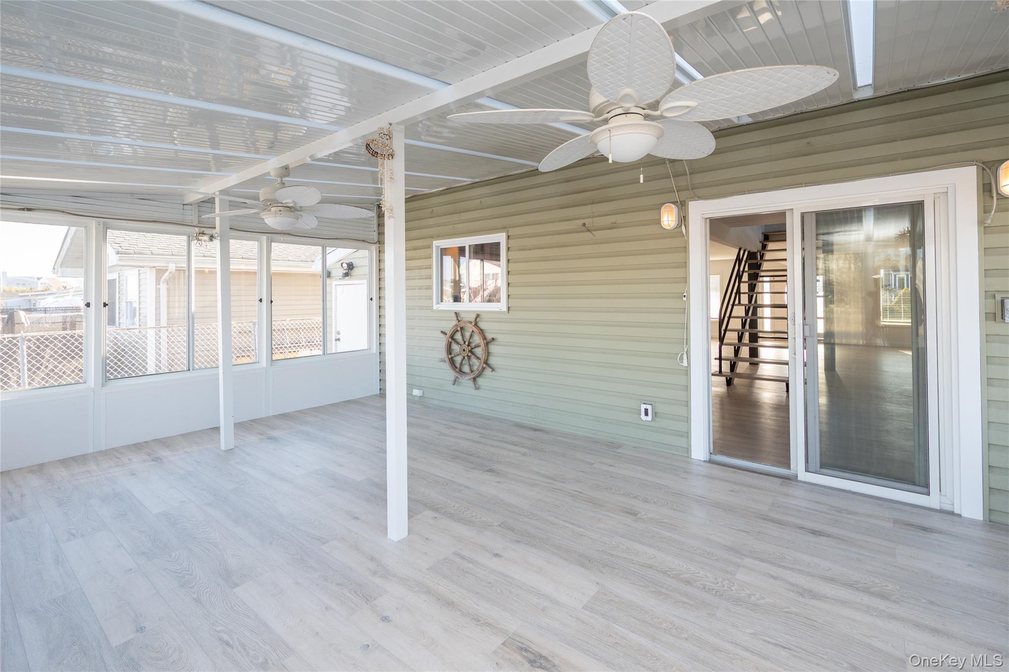 15 Roneck Court Shirley, NY 11967 - Photo 16 of 44 a view of an empty room with wooden floor and a window