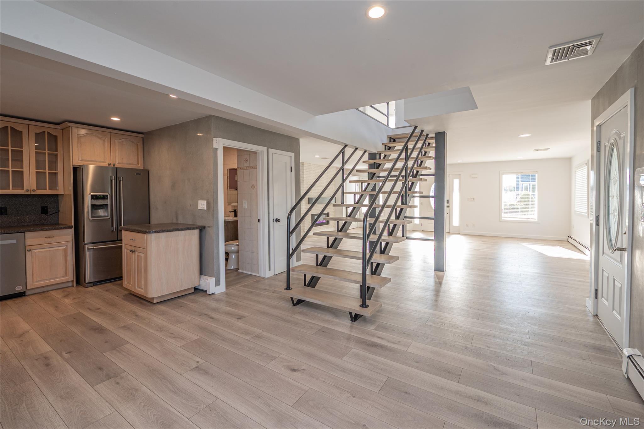 15 Roneck Court Shirley, NY 11967 - Photo 44 of 44 a view of a livingroom with wooden floor and stairs
