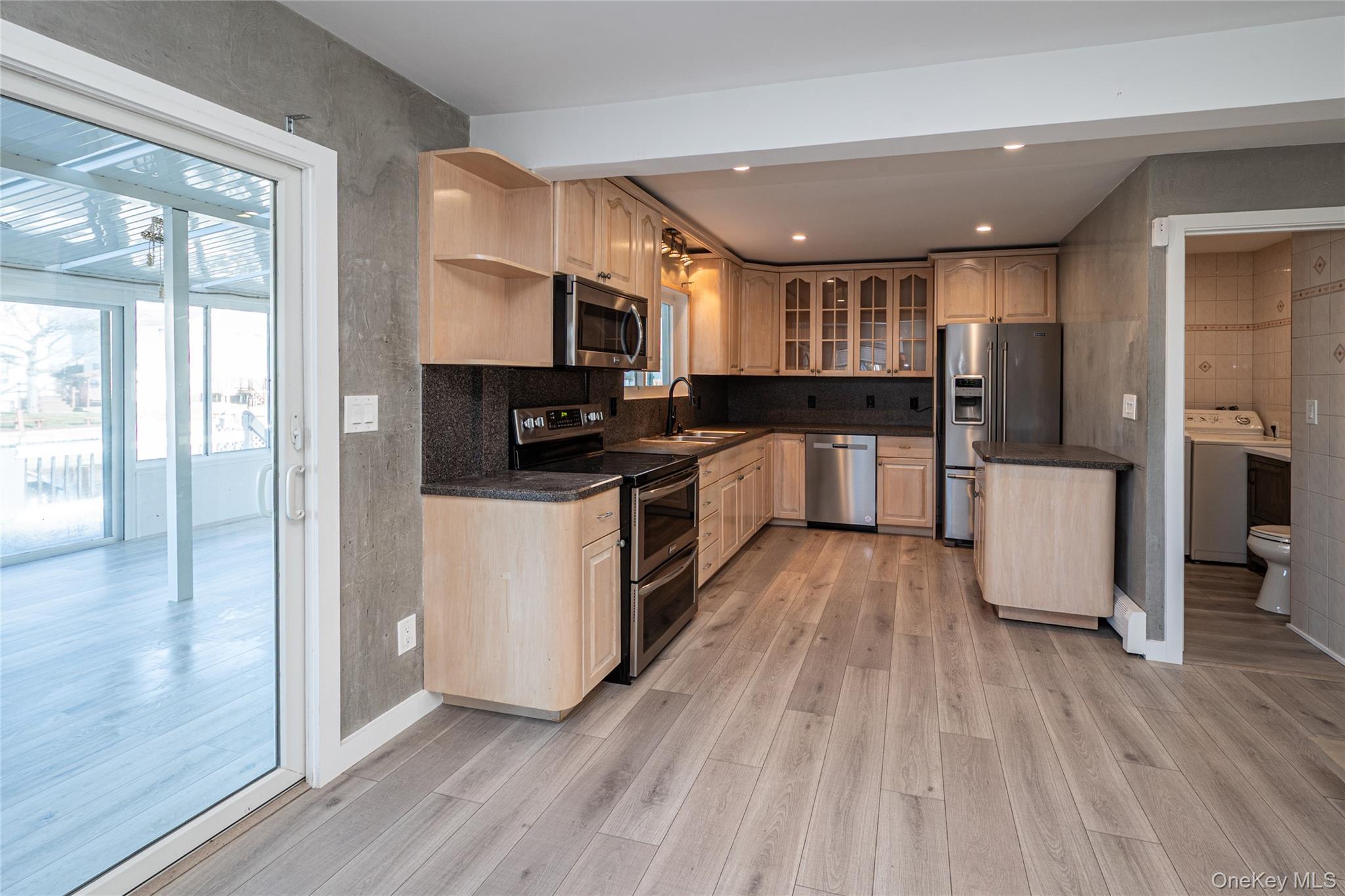 15 Roneck Court Shirley, NY 11967 - Photo 18 of 44 a kitchen with stainless steel appliances a refrigerator sink and cabinets