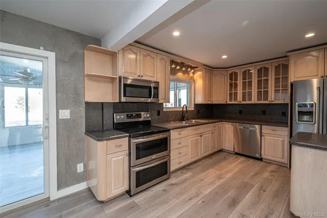 a kitchen with stainless steel appliances a refrigerator sink and cabinets
