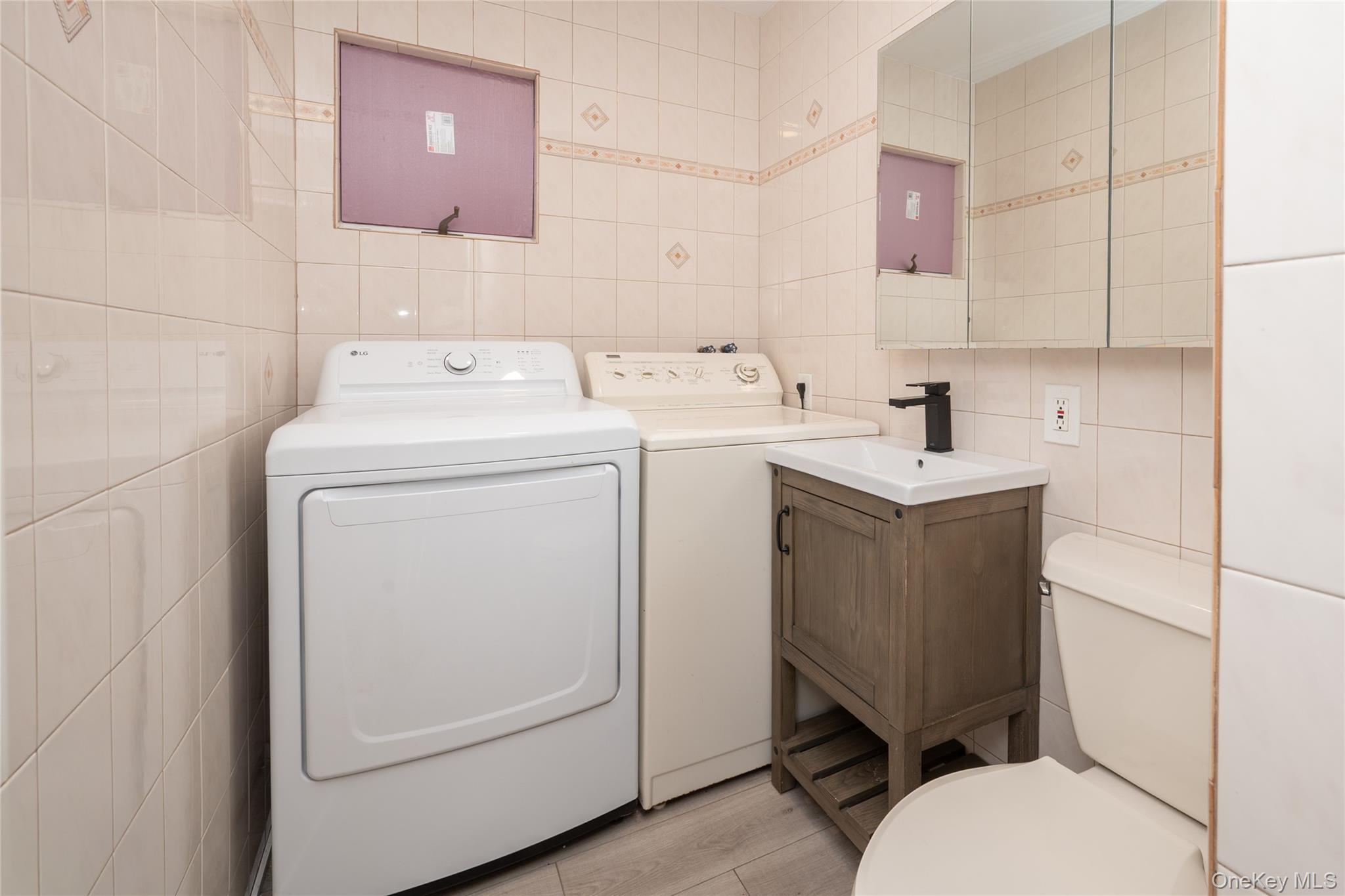 15 Roneck Court Shirley, NY 11967 - Photo 22 of 44 a bathroom with a sink toilet and mirror