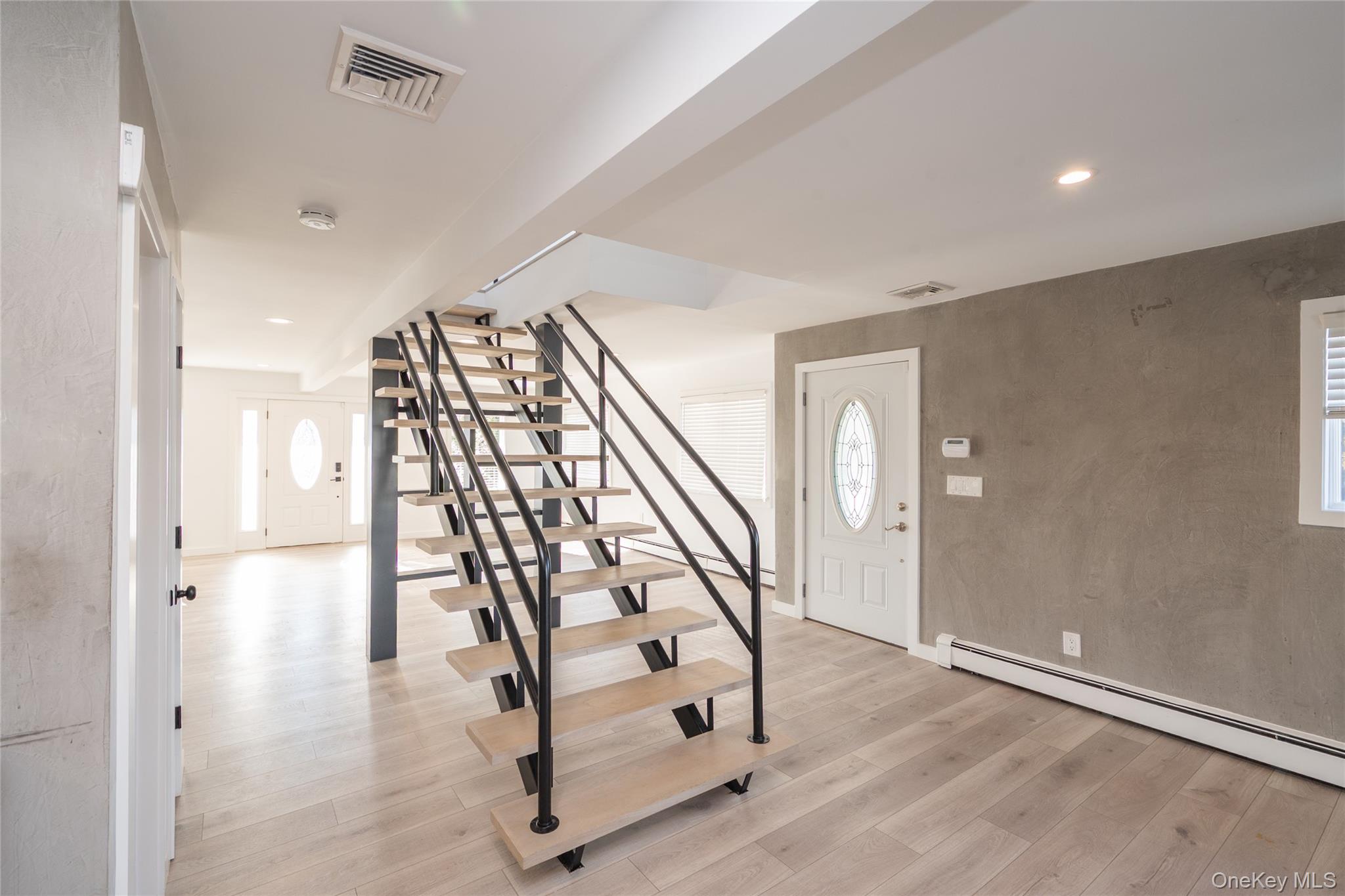 15 Roneck Court Shirley, NY 11967 - Photo 23 of 44 a view of an entryway with wooden floor