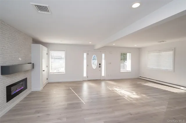 a view of an entryway with wooden floor