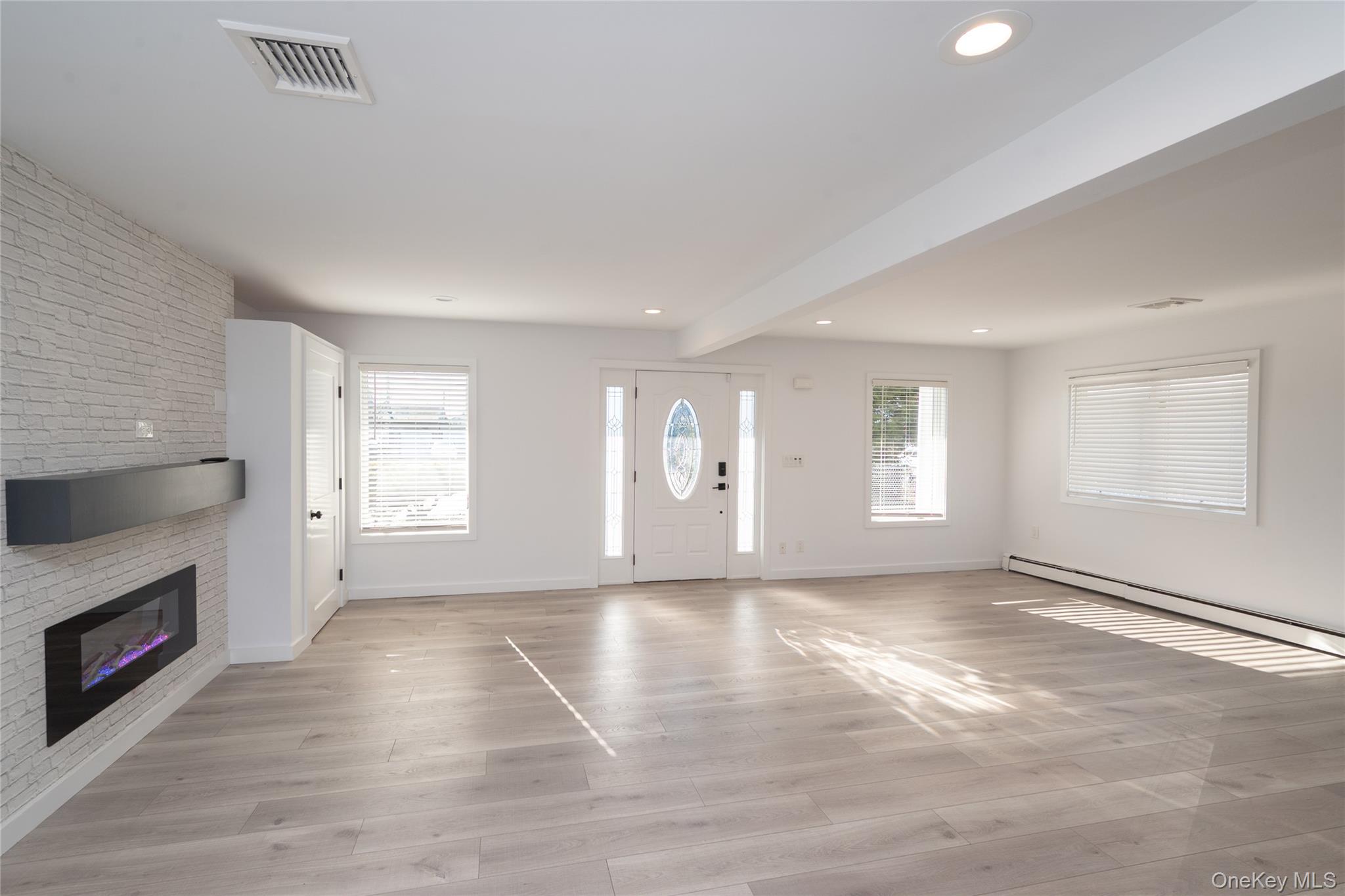 15 Roneck Court Shirley, NY 11967 - Photo 24 of 44 a view of an empty room with a window and fireplace