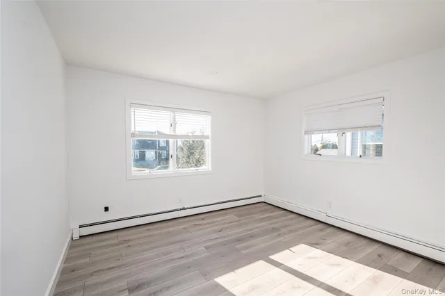 a view of a room with wooden floor