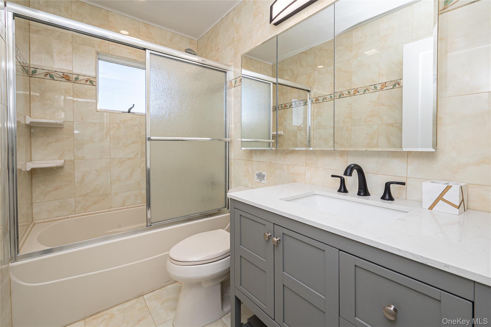 15 Roneck Court Shirley, NY 11967 - Photo 29 of 44 a bathroom with a sink a toilet and a bathtub