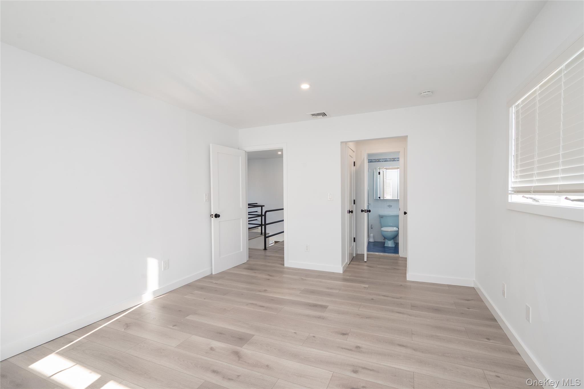 15 Roneck Court Shirley, NY 11967 - Photo 35 of 44 a view of empty room with wooden floor