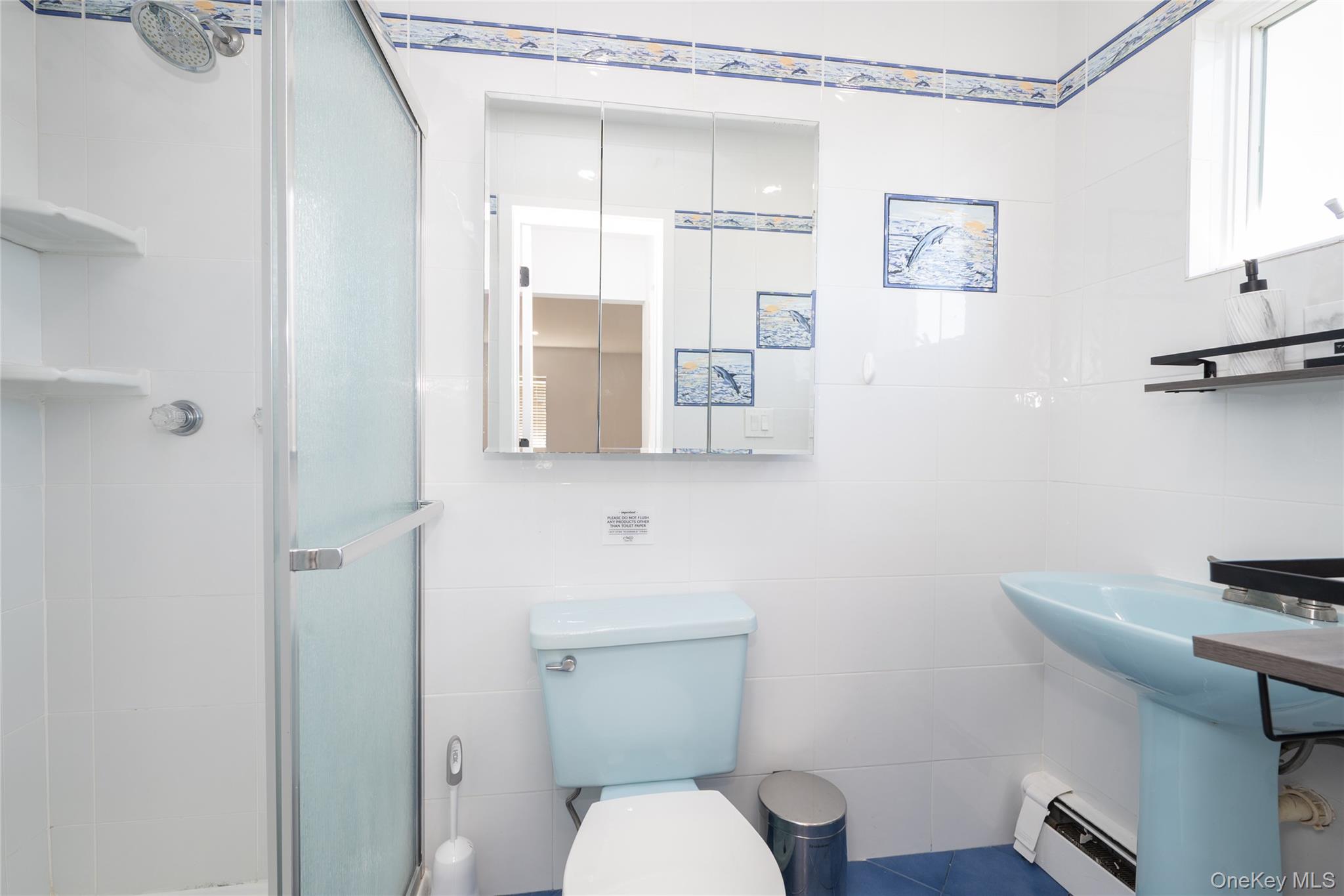 15 Roneck Court Shirley, NY 11967 - Photo 36 of 44 a white toilet sitting next to a bathroom sink