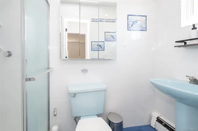 a white toilet sitting next to a bathroom sink