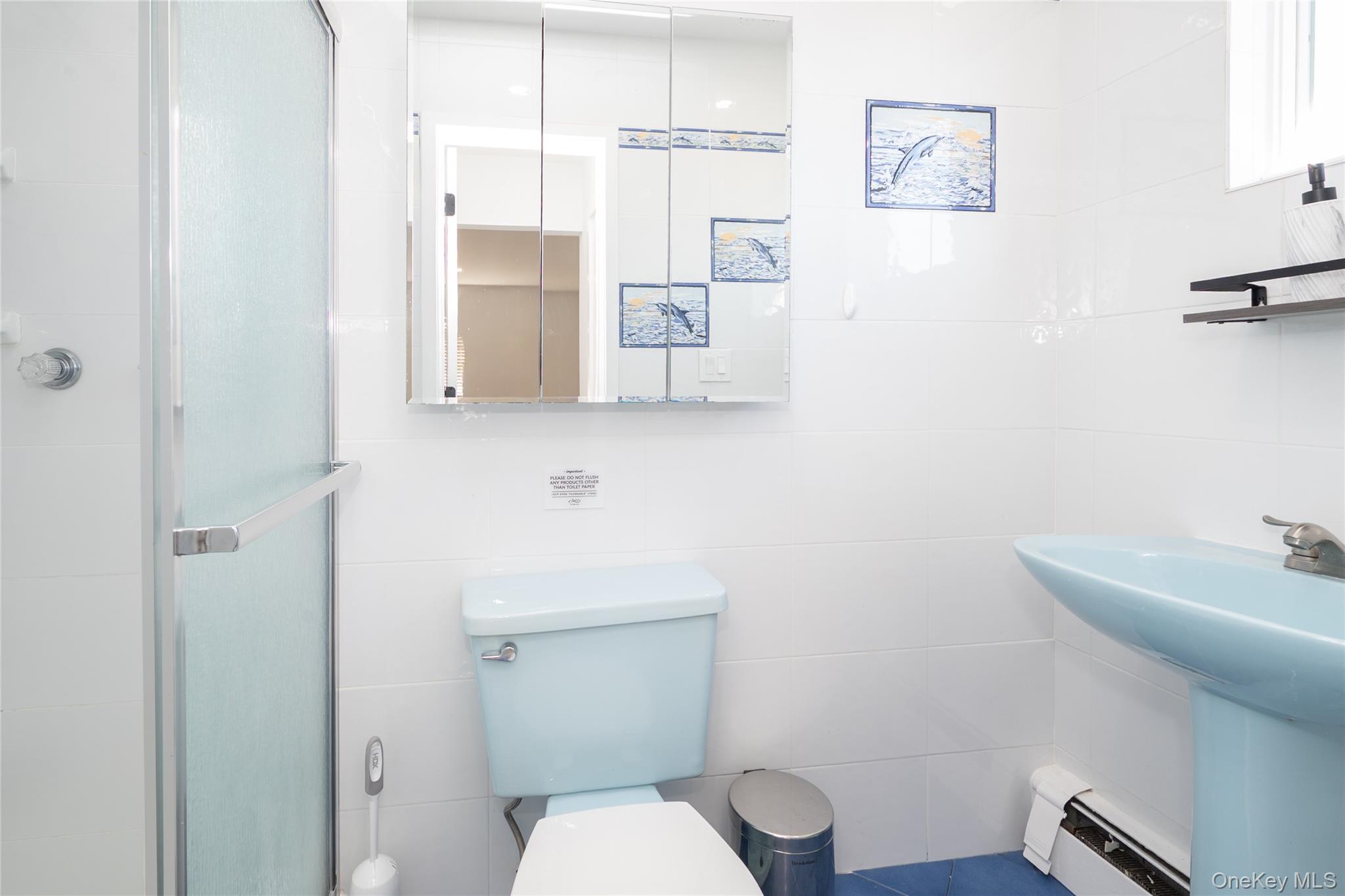 15 Roneck Court Shirley, NY 11967 - Photo 37 of 44 a bathroom with a toilet sink and mirror