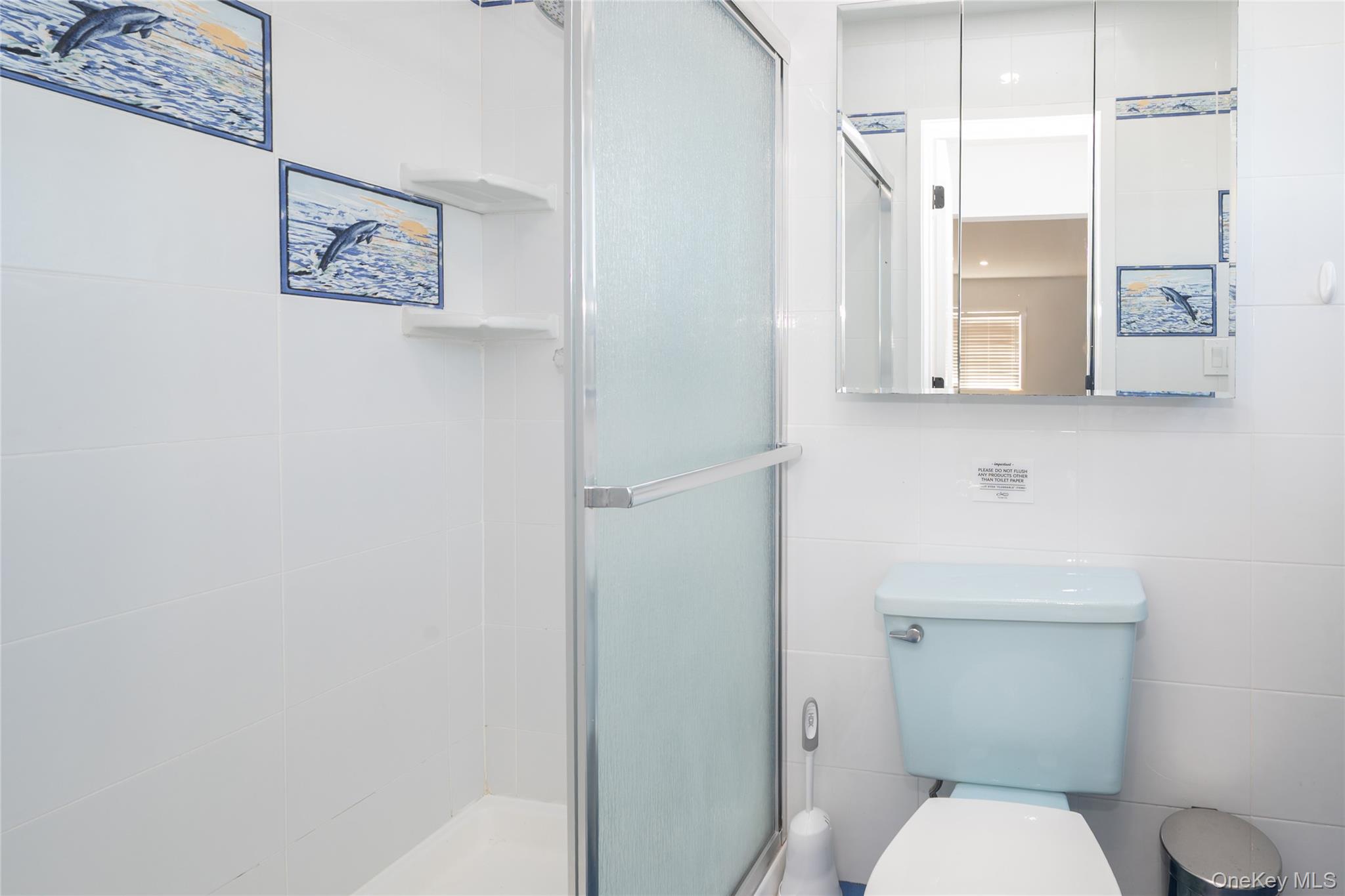 15 Roneck Court Shirley, NY 11967 - Photo 38 of 44 a bathroom with a toilet and a shower