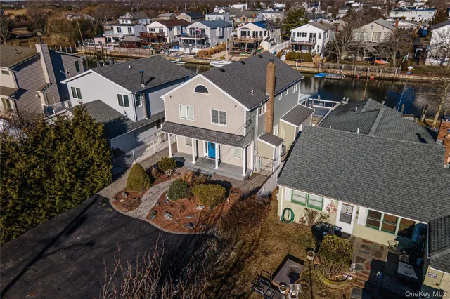 an aerial view of a house with yard swimming pool and ocean view