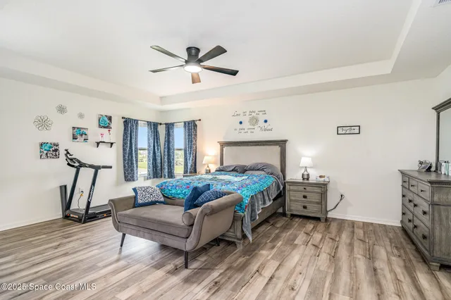 a bedroom with furniture and a wooden floor