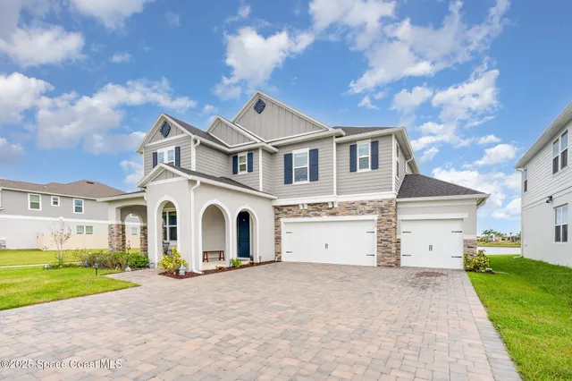 a view of a white house with a yard