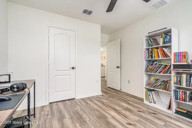 a view of room with lounge chair and book shelf