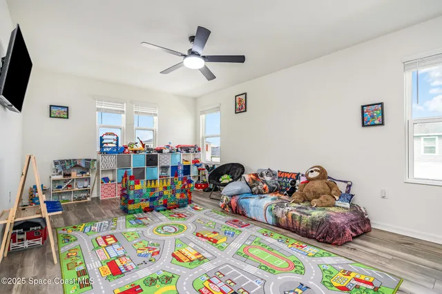 a bed room with furniture and a wooden floor