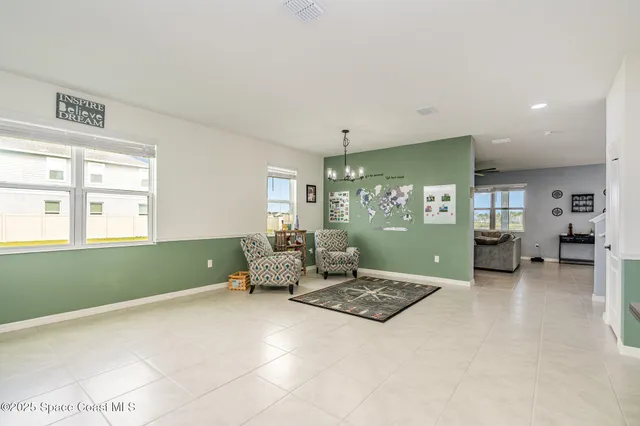 a living room with furniture and large window