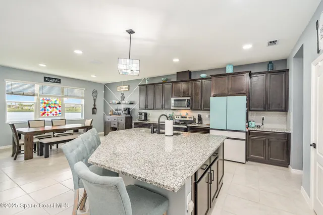a large kitchen with a table and chairs