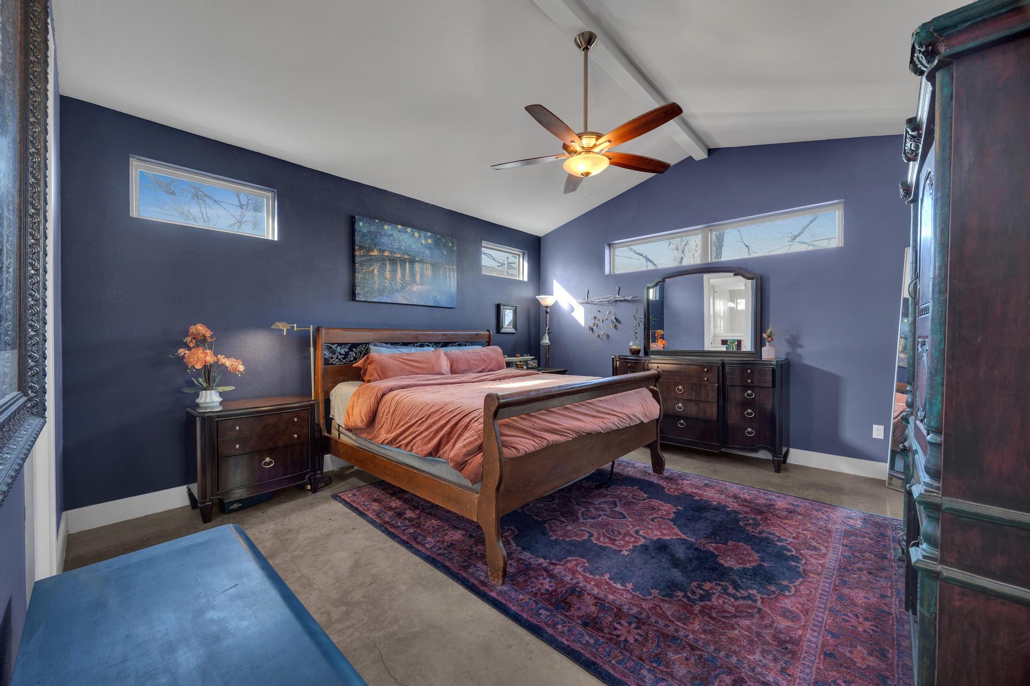 4404 Clarkson Avenue Austin, TX 78751 - Photo 13 of 35 a bedroom with a bed and a chandelier