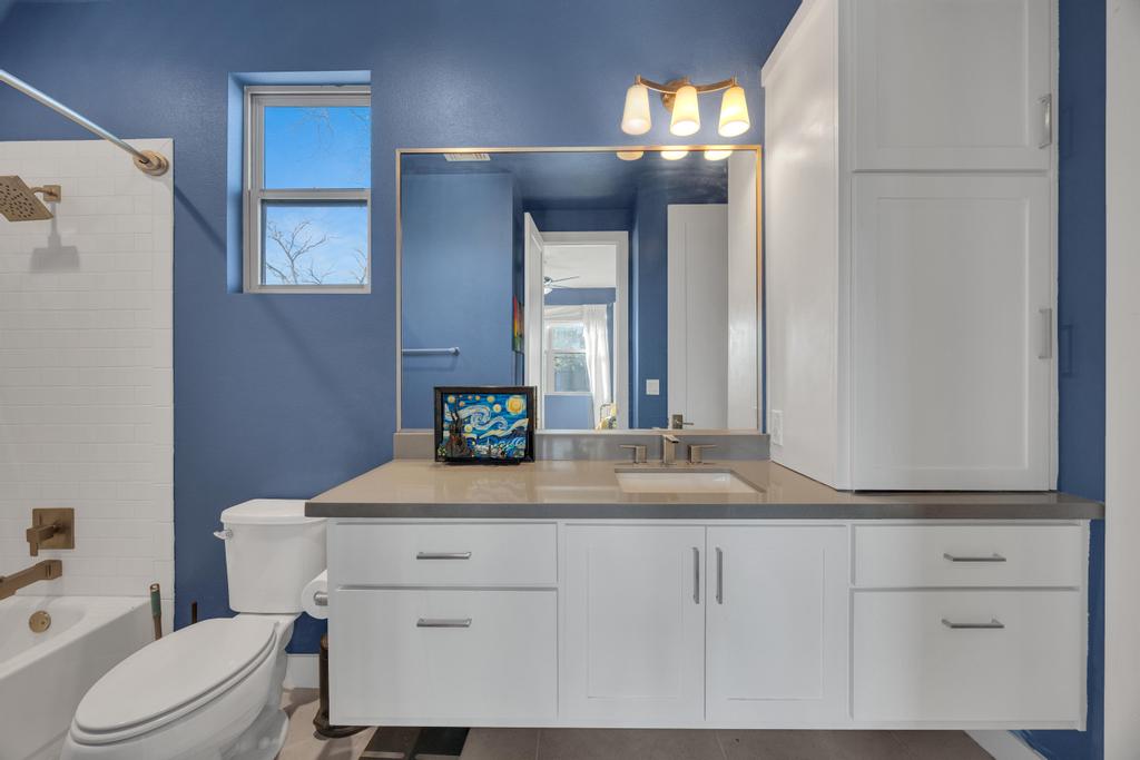 4404 Clarkson Avenue Austin, TX 78751 - Photo 20 of 35 a bathroom with a toilet a sink and mirror